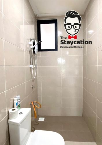 a bathroom with a toilet and a sign on the wall at Staycation Homestay 14 P Residence kuching condo in Kuching