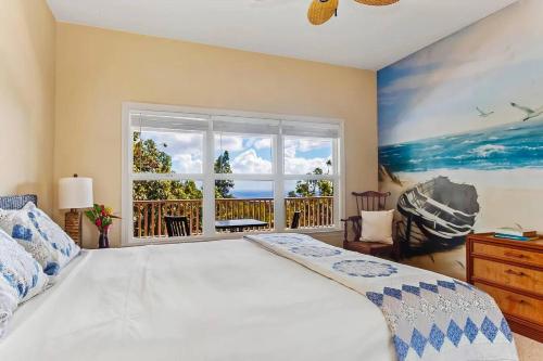 a bedroom with a large bed and a window at Treetop Oasis in Kakela Maki in Kalaheo