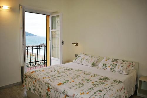 una camera da letto con un letto con vista sull'oceano di Hotel Residence Baiadelsole a Laigueglia