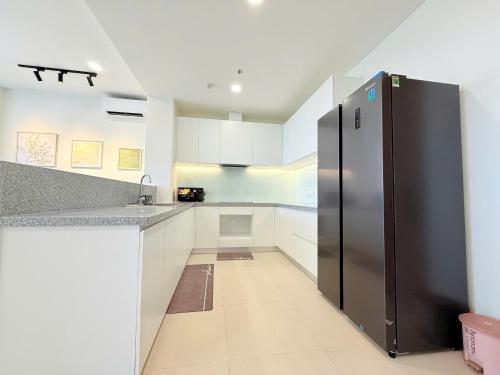 a large kitchen with a stainless steel refrigerator at Homie's The Glory Apartment in Thu Dau Mot