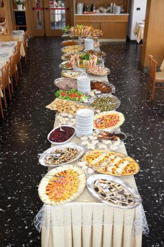 a long line of plates of food on a table at Hotel Peselli in Marina di Massa