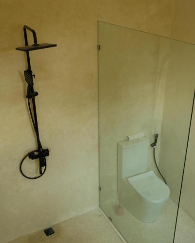 a bathroom with a toilet and a shower stall at Villa Sundara 2BR Private Pool in Mantaak