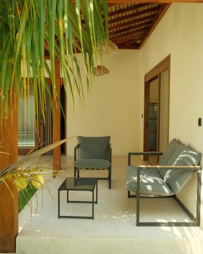 a living room with two chairs and a table at Villa Sundara 2BR Private Pool in Mantaak
