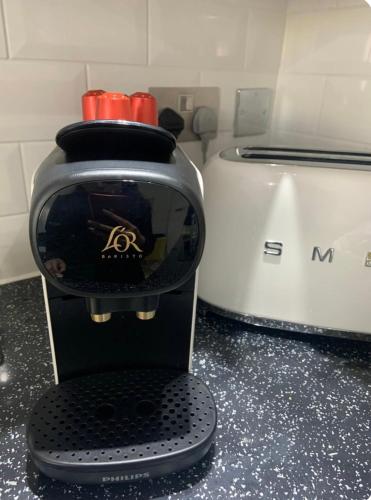 a blender sitting on a counter next to a toaster at Winners of 2025 traveller Award, Elegant two bedroom city central apartment with Netflix & WiFi in Leeds