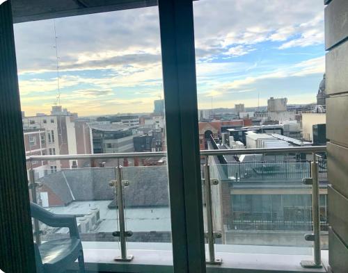 a view of a city from a window at Winners of 2025 traveller Award, Elegant two bedroom city central apartment with Netflix & WiFi in Leeds