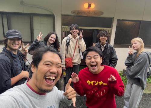 a group of people are posing for a picture at 高野山ゲストハウス ラフテル Koyasan Guest House Laugh Tale in Hashimoto