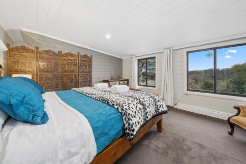 une chambre avec un grand lit et une fenêtre dans l'établissement Broughton Cottage, à Katoomba