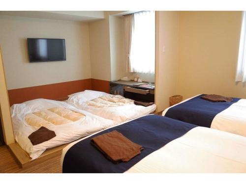 Postel nebo postele na pokoji v ubytování Hotel WBF Grande Asahikawa