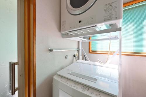 a washer and dryer in a kitchen with a washing machine at 間 はざま in Shodoshima