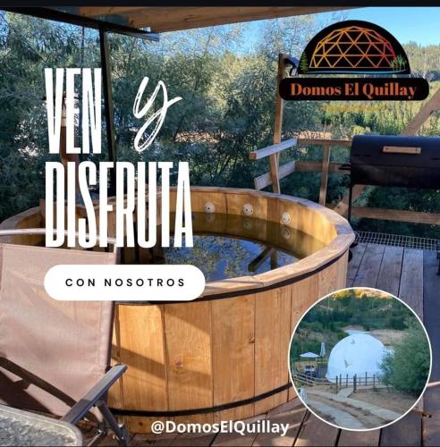 a hot tub on a deck with a sign at Domos el Quillay in Concepción