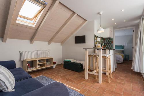 a living room with a couch and a table at Casas da Formosa - Casa do Postigo in Tavira