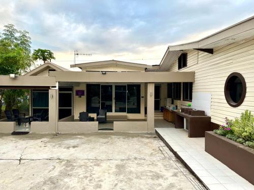 a house with a patio and a building at Large 3bdr Holiday Home Great Location Labasa Jumanzuls Abode in Labasa