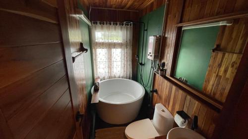 a bathroom with a tub and a toilet in a room at The Floating Lake House in Ban Pracham Mai Bon