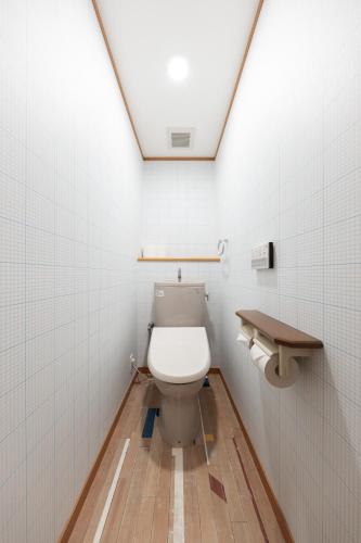 a bathroom with a toilet and a skylight at Asobi TABI-NE in Kanazawa