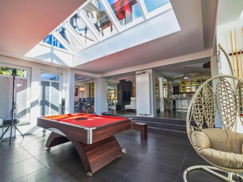 a pool table in a living room with a skylight at Apartment with bar, recreation room in Kastellaun in Kastellaun
