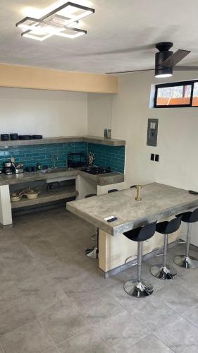 a large kitchen with a table and some chairs at Casa Marlin in Mulegé