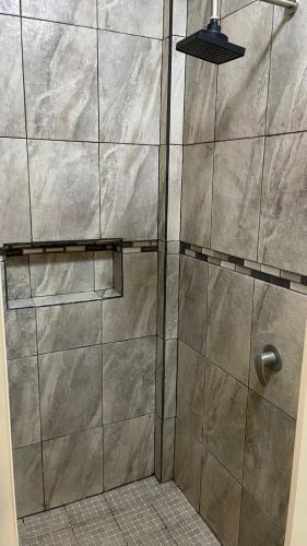 a shower with a glass door in a bathroom at Casa Marlin in Mulegé