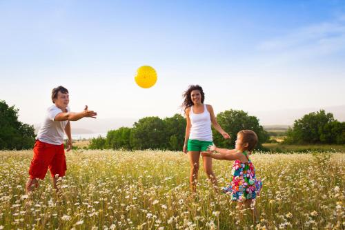 a group of people playing with a frisbee in a field at Stunning 6 Berth Lodge With Decking At Valley Farm Holiday Park Ref 46735V in Great Clacton