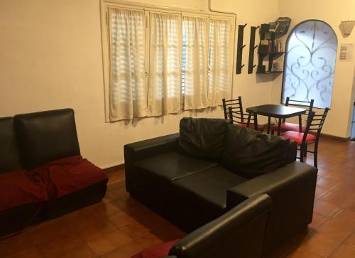 a living room with a couch and a table at Hostel Lagares in Mendoza