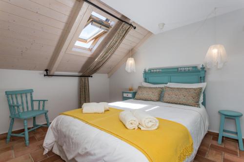 a bedroom with a large bed with towels on it at Casas da Formosa - Casa do Postigo in Tavira