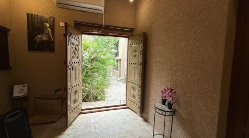 a hallway with an open door with a view at Omani Guest House نزل البيت العماني in Nizwa
