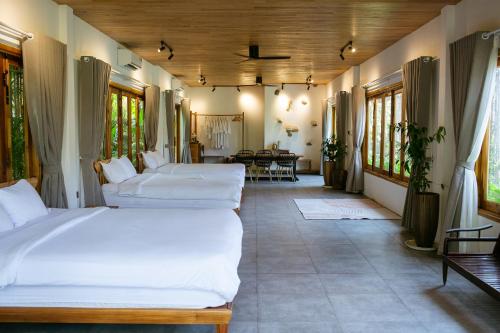 a bedroom with three beds in a room at Tổ Boutique Garden in La Gi