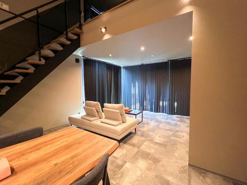 a living room with a couch and a table at LIFEMENT GLANZ Okimi in Etajima