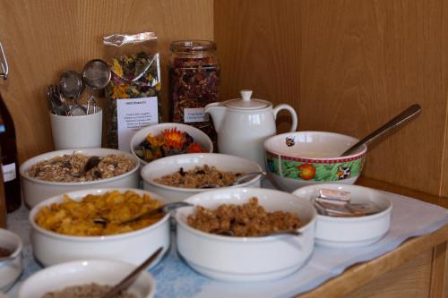 a table topped with bowls of food on a counter at Garni Reider in Meltina