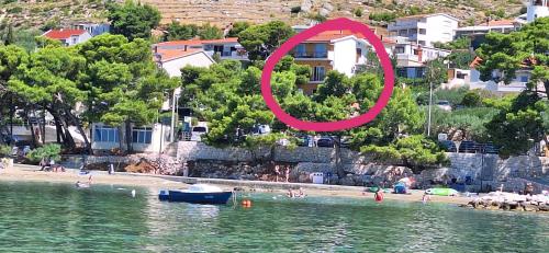 a view of a beach with a red circle on it at Summerhouse Duće Omiš in Duće