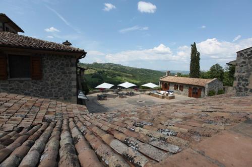 a large stone patio with a building and a group of buildings at Agriturismo Lapone in Orvieto