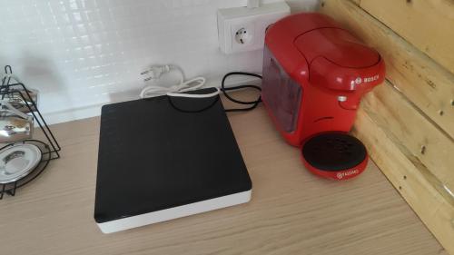 a table with a toaster and a laptop on it at El Rincón Coqueto in Pinoso