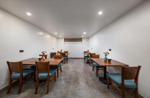 a dining room with wooden tables and chairs at Tam Coc Sueno Hotel in Ninh Binh