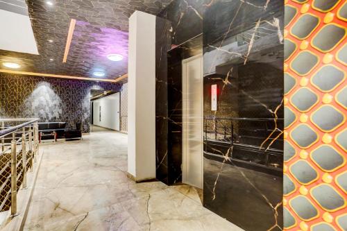 a lobby with black walls and marble floors at Palette Hotel and Resort Bareilly Formerly Bellazio Suites in Bareilly