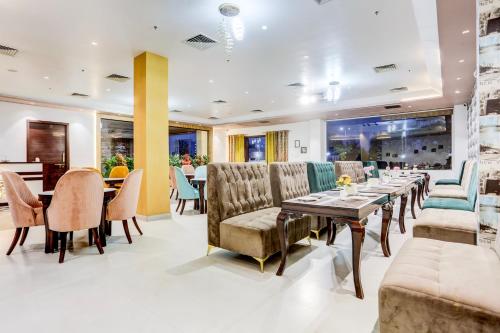 a dining room with a table and chairs at Palette Hotel and Resort Bareilly Formerly Bellazio Suites in Bareilly