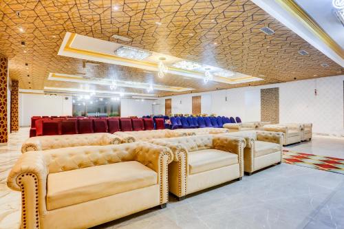 a room with couches and chairs in a room at Palette Hotel and Resort Bareilly Formerly Bellazio Suites in Bareilly