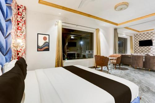 a bedroom with a bed and a living room at Palette Hotel and Resort Bareilly Formerly Bellazio Suites in Bareilly