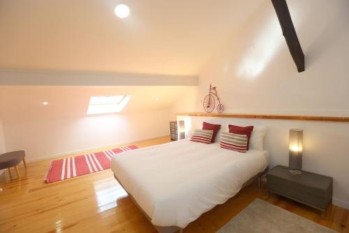 a bedroom with a white bed with red pillows at Enjoy Lisbon Alfama 2 in Lisbon