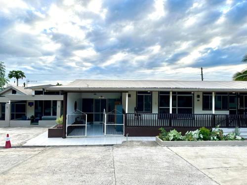 a school building with a porch and a cloudy sky at Furnished Modern Unit Great Location Labasa Jumanzuls Abode in Labasa