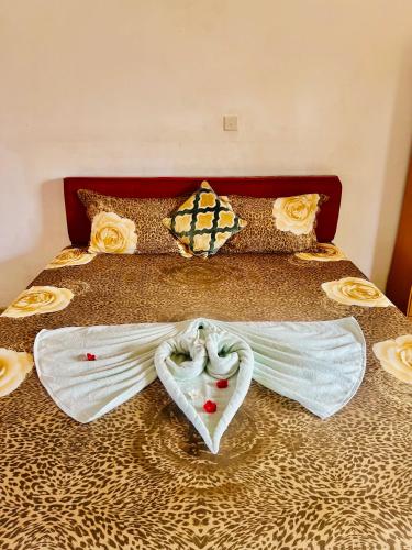 a bed with two white towels on it at The Family Beach Villa in Uswetakeiyawa
