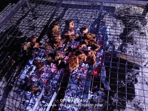 a grill with some food on top of it at Homestay Eco in Jalpāiguri
