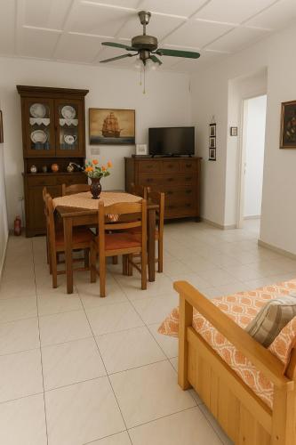 a living room with a table and chairs and a tv at Traditional Family House in Grizáta