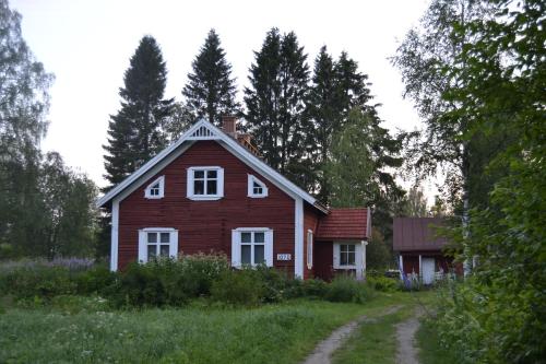 a red house in the middle of a field at Idyllic Peltola in Ranua