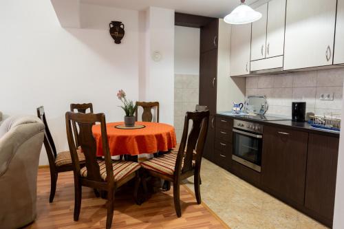 a kitchen with a table and chairs in a room at GRADINA - Stan na dan in Doboj
