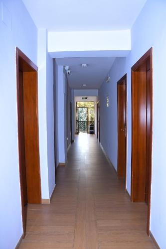 a hallway with blue walls and wooden doors at Sun View Hotel in Addis Ababa