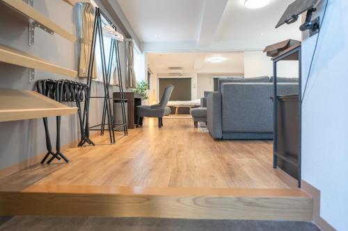 a living room with a couch and a table at Nestry Asakusa 502号室 in Tokyo