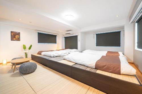 two beds in a room with two windows at Nestry Asakusa 502号室 in Tokyo