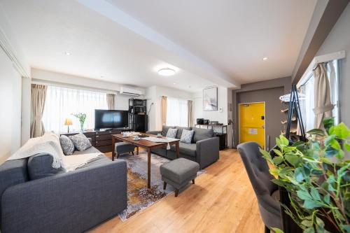 a living room with a couch and a table at Nestry Asakusa 502号室 in Tokyo
