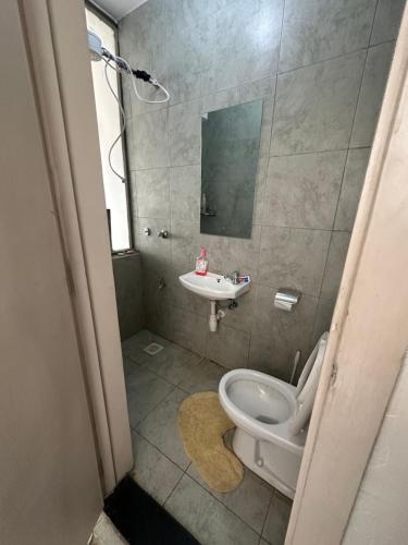 a bathroom with a toilet and a sink at WONDERs HOME in Nairobi