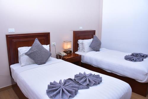 a hotel room with two beds with bows on them at Sun View Hotel in Addis Ababa