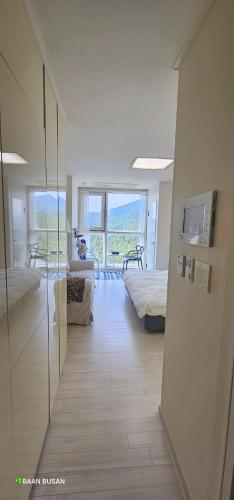 a room with a bedroom with a bed and a television at Baan Busan - 3mins to Haeundae Beach in Busan